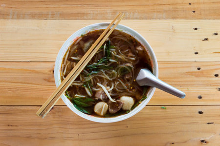 Rice noodle soup Cut White with Bean Sprout and Pork meatballs in a cup on a wooden background.の写真素材