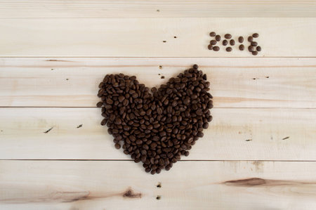 Coffee beans arranged shaped heart 2016 on wood background.の写真素材