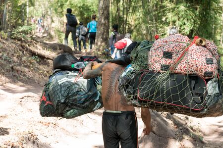 Loei / Thailand - Dec 2016:Strongest Man hired baggage of an on Phu Kradueng, Loei,Thailand on Dec 26, 2016 in Loei Thailand.のeditorial素材