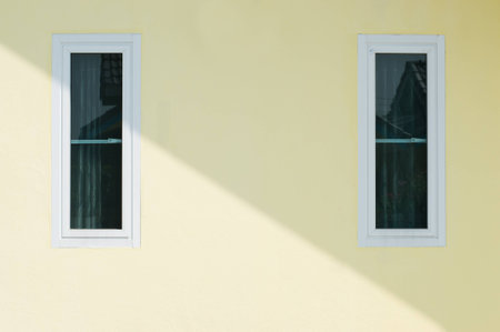 wall yellow house with two windows.の写真素材