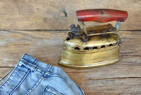 Old days flat iron made of brass. The upper part with handle can be lifted up to fill with lit charcoal.の写真素材