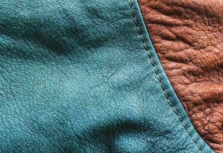 Leather jacket seam.Leather texture of a jacket showing the seam at shoulder of green color and brown of the arm.の写真素材