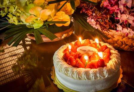 Candles light on strawberry birthday cake.So delightful.の写真素材
