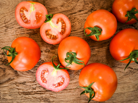 Fresh tomatoes on wood background. Organic vegetable for healthy eating.の写真素材