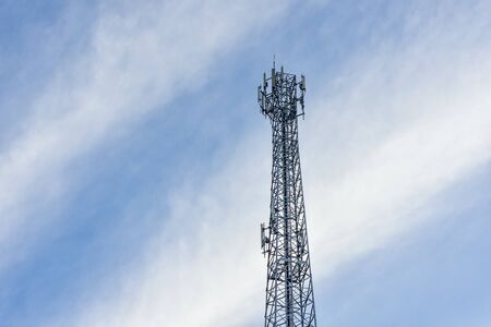 Telecommunication, wireless communication with evening blue sky and fluffy clouds background.Transmitter station tower for telecommunication industry.の写真素材