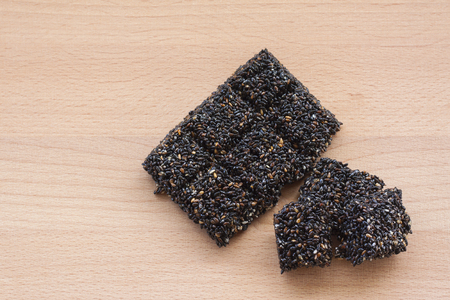 black sesame seeds on spoon isolated on white background.の写真素材