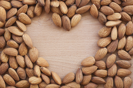 Almonds on a white background, or on a plain wooden table.の写真素材