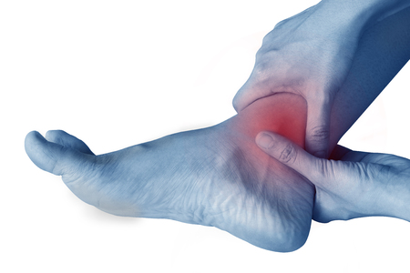 women has inflammation and swelling cause a pain the sore ankle, isolated on white background.の写真素材