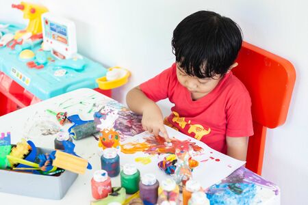 Children playing with watercolor stay at home. little boy and water colors.の写真素材