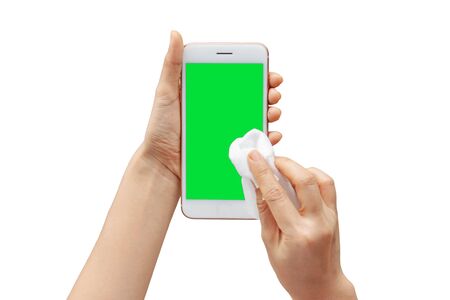 Thai woman hand shows mobile smartphone with green screen in vertical position isolated on white background.の写真素材