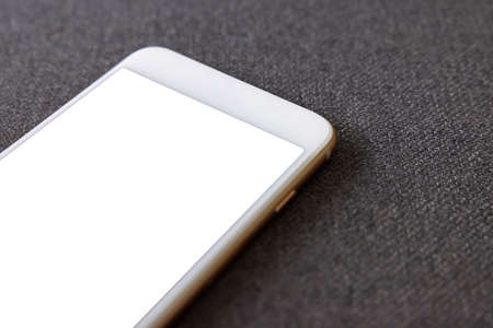 smart phone white screen on sofa in the living room. Concept of technology, connection, communication.の写真素材