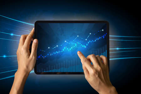 Close-up Of Business man's hand holding tablet showing stock market statistics gain profits and increase of chart positive indicators. Financial analysis, statistics. Concept of business strategyの写真素材