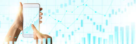 Close-up Of Business man's hand holding smartphone showing stock market statistics gain profits and...