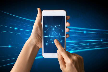 Close-up Of Business man's hand holding smartphone showing stock market statistics gain profits and increase of chart positive indicators. Financial analysis, statistics. Concept of business strategyの写真素材