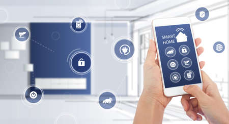 Hand of woman or man holding smartphone in house with icons in modern life internet of things, smart...