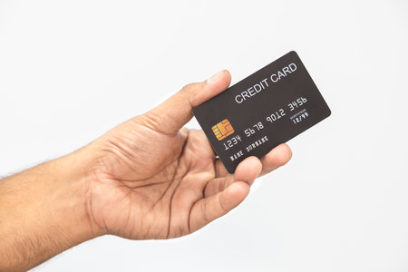 Close-up hand of Asian man holding black credit card in his hand. isolated on white background. Concept of finance, trading, communication, social, technology, business.の写真素材