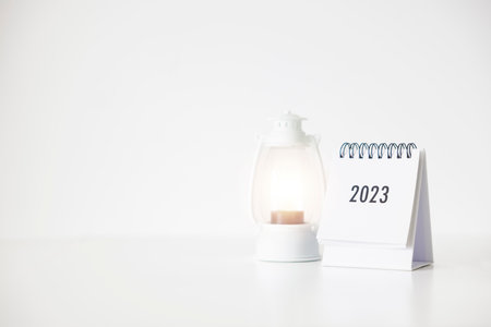 2023 business calendar and lamp on office table in new year day. Make a work plan for the start of...