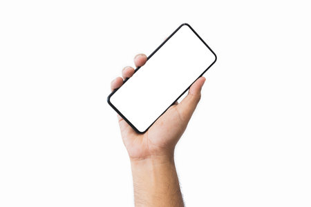 Male hand holding black smartphone with blank screen and modern frameless design two positions angled copy space isolated on white background. close-up hand of man hold mobile phone. Space for text.の写真素材