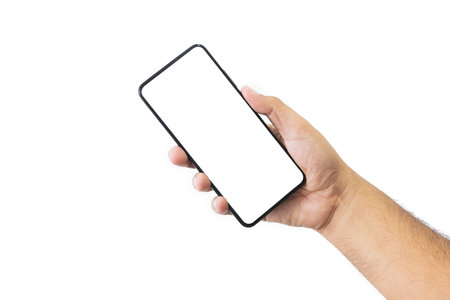 Male hand holding black smartphone with blank screen and modern frameless design two positions angled copy space isolated on white background. close-up hand of man hold mobile phone. Space for text.の写真素材