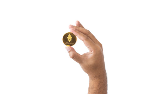 close-up hand of man holding crypto coin copy space isolated on white background. Blockchain technology finance in future. Male hand hold Ethereum. concept about business, finance, trade, economy.の写真素材