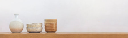 Satai Modern pottery lies on a wooden shelf against a white wall background. Handmade pottery. Thailand's native handicrafts.の写真素材