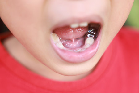 Child milk teeth fall out from gum. little boy permanent tooth grows in mouth. Cute kid open her mouth show Dental Crown and gums. Concept of health, dentist, hygiene, medical, Healthy teeth, clinic.の写真素材
