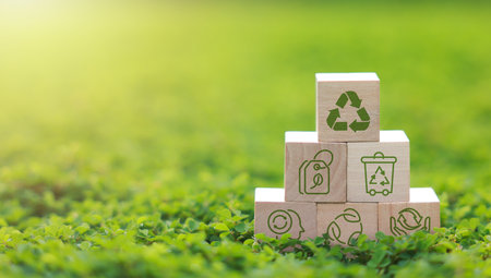 Wooden block with icons for recycling, recycling symbol, bins, plastic bottles and reducing carbon emissions, protect the environment, reducing waste, recycling materials. earth day.の写真素材