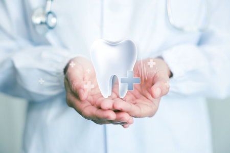 Health dental care concept. male doctor dentist holding dental tooth with icons. medical health and dentistry concept.  can be used in children dentist clinic or hospital.の写真素材