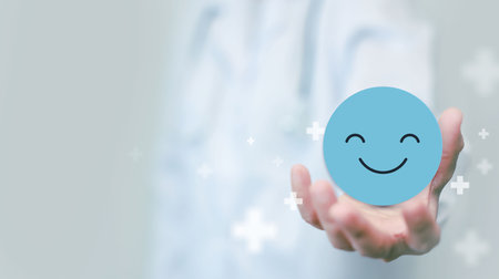 Medical concepts. doctor holding paper cut circle symbol face smile, happy, relax, satisfaction survey, positive, good, wellness, health child, hospital, world mental health day concept.の写真素材