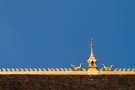 the roof top decoration of buddhism temple in Thailandの写真素材
