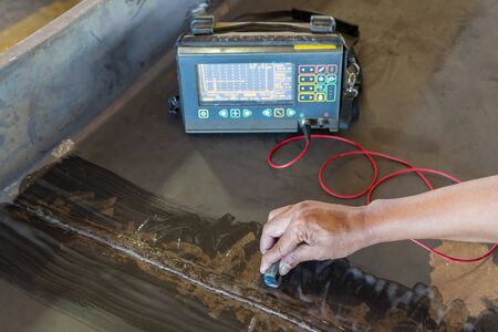 Checking defect in welded of steel add joint with process Ultrasonic testing (UT) of Non-Destructive Testing(NDT) at industrial factory.の写真素材