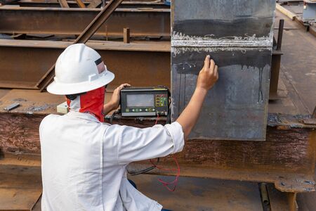 The inspectors are checking defect in welded of steel add joint with process Ultrasonic testing (UT) of Non-Destructive Testing(NDT) at industrial factory.の写真素材