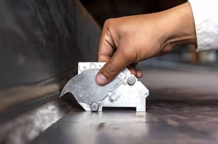 Using the welding gauge to measure the leg length of welding process Submerged Arc Welding(SAW)の写真素材