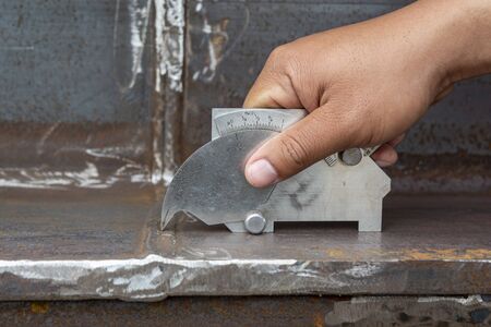 Using the welding gauge to measure the Convexity And Weld Reinforcement of the welded.の写真素材