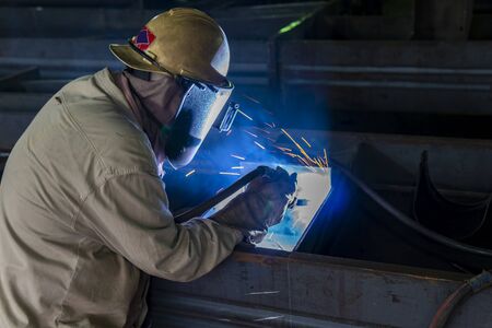 The welder is welding a steel structure work with process Flux Cored Arc Welding(FCAW) and dressed...