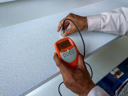 Measure Dry Film Thickness (DFT) with Coating Thickness Gauge for fireproof painting on steel structure, at industrial factory.の写真素材