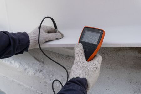 Measure Dry Film Thickness (DFT) with Coating Thickness Gauge for fireproof painting on steel structure, at industrial factory.の写真素材