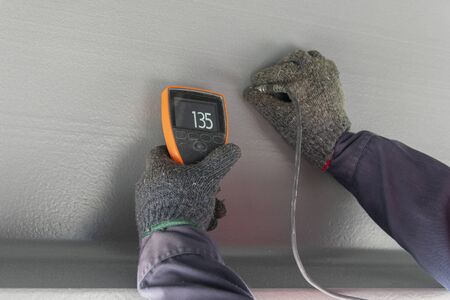 Measure dry film thickness (DFT) with Coating Thickness Gauge for painting on steel structure, at industrial factory.の写真素材