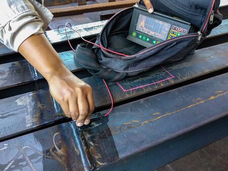 Checking defect in welded of steel add joint with process Ultrasonic testing (UT) of Non-Destructive Testing(NDT) at industrial factory.の写真素材