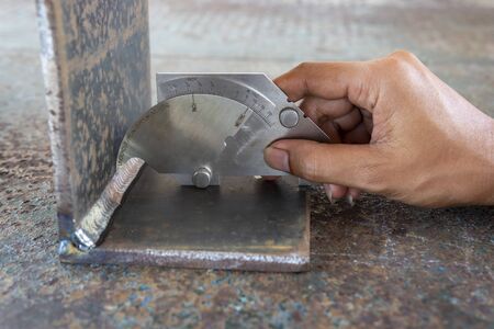 Using the welding gauge to measure the leg length of welding process Flux Cored Arc Welding (FCAW)の写真素材