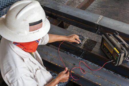 The inspectors are checking defect in welded of steel add joint with process Ultrasonic testing (UT)...