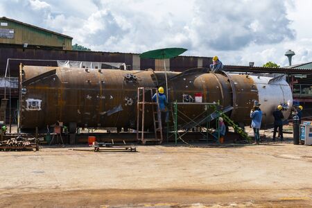 workers are helping to fix the defects of the welding work and damage on the stack at industrial factory.の写真素材