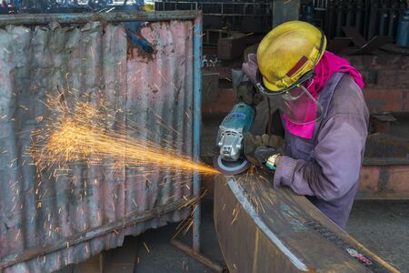 Men is used Grinding Machine to Grinding welded on steel structure, at Industrial factory.の写真素材