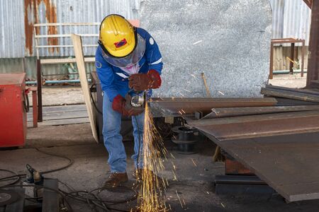 Worker is used Grinding Machine to grinding surface of H-Beam steel after cutting, at Industrial...