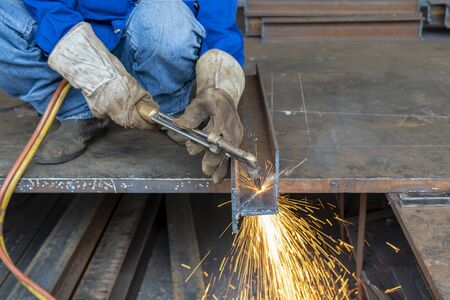 H-beam steel cutting with Hand Gas Cutting Torches, at industrial factory.