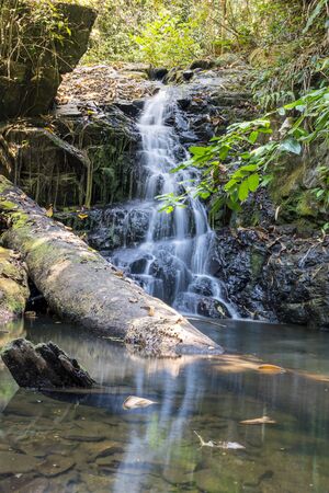 Spontaneous waterfall flows down from the mountain.の写真素材