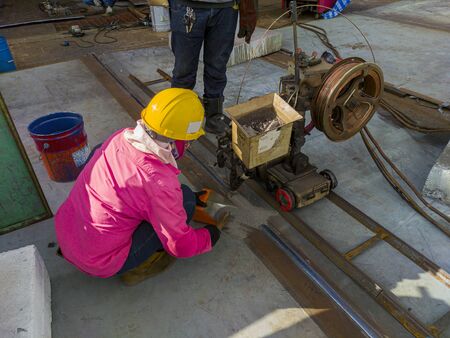 The welder is welding add joint a steel plate with process Submerged Arc Welding(SAW) at industrial...