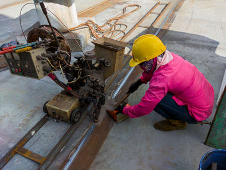 The welder is welding add joint a steel plate with process Submerged Arc Welding(SAW) at industrial factory.の写真素材