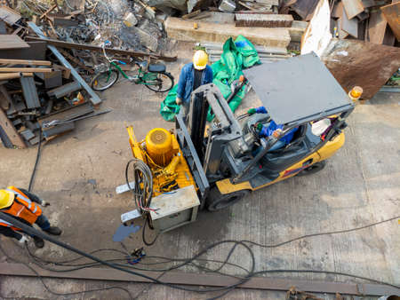 The forklift is lifting the steel bending machine. Come to the installation site before bending the steel plate.の写真素材