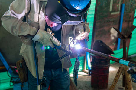 Welder is working welding pipe carbon with process Tungsten Inert Gas Welding (TIG) or Gas Tungsten...